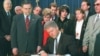 El presidente Bill Clinton promulga la Ley Helms-Burton. A su izquierda el congresista Bob Menendez y el senador Jesse Helms. 